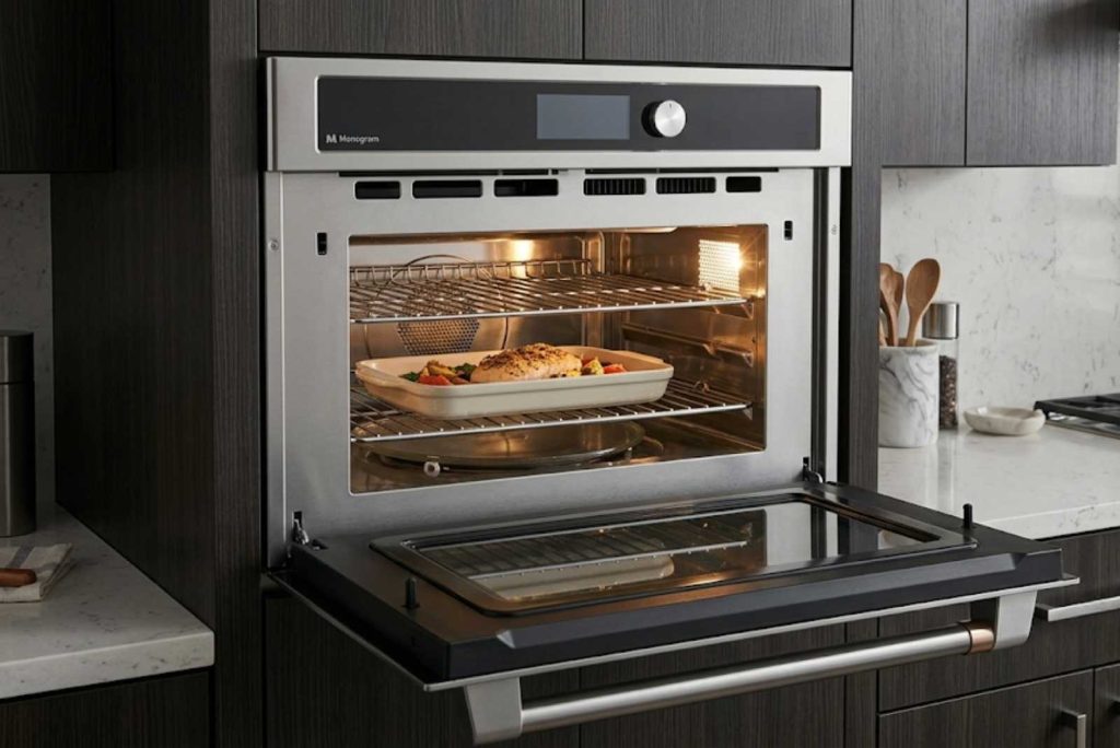 GE Monogram Advantium speedcook oven built into a wall cabinet with the door open