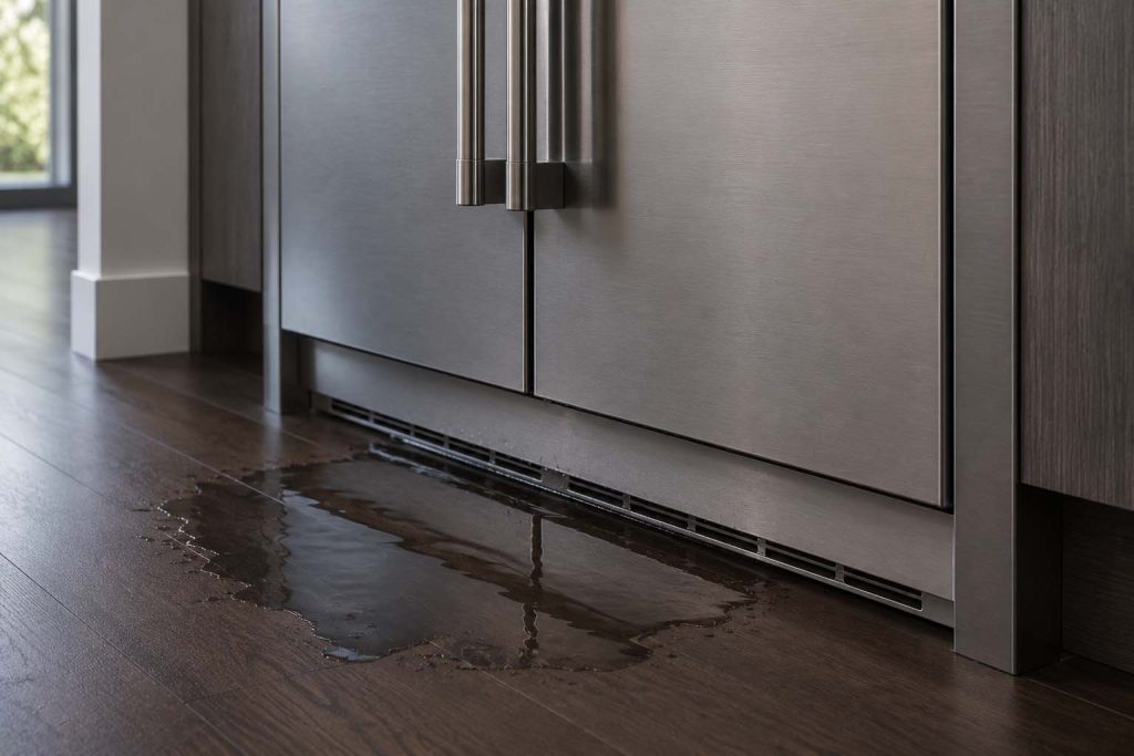 Water pooling at the toe kick of a GE Monogram built-in refrigerator column