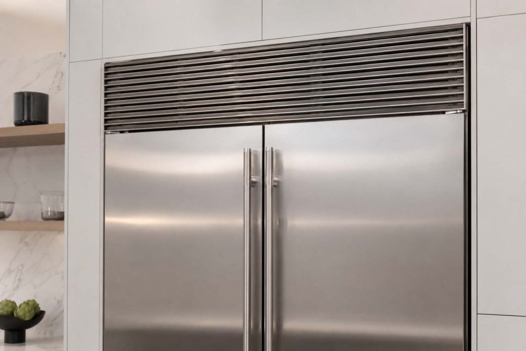 GE Monogram built-in refrigerator with top compressor grille, the usual source of abnormal noise